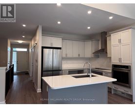 A modern kitchen with white cabinets and a large island.