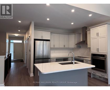 A modern kitchen with white cabinets and a large island.