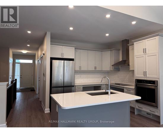 A modern kitchen with white cabinets and a large island.