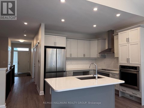 A modern kitchen with white cabinets and a large island.