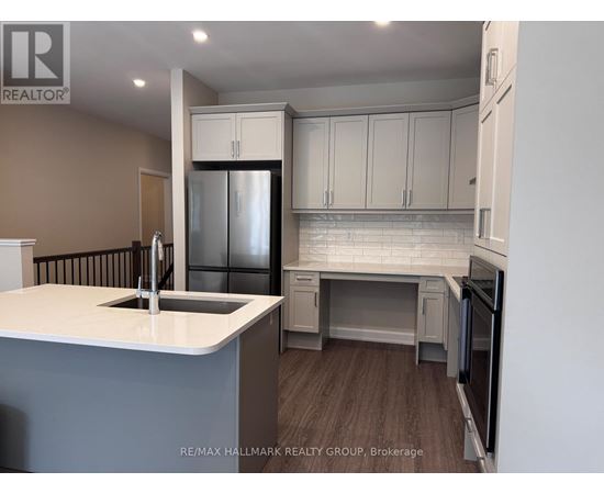 A kitchen with a white countertop and a refrigerator.