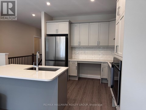 A kitchen with a white countertop and a refrigerator.