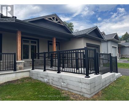 A house with a black fence and a grey roof.