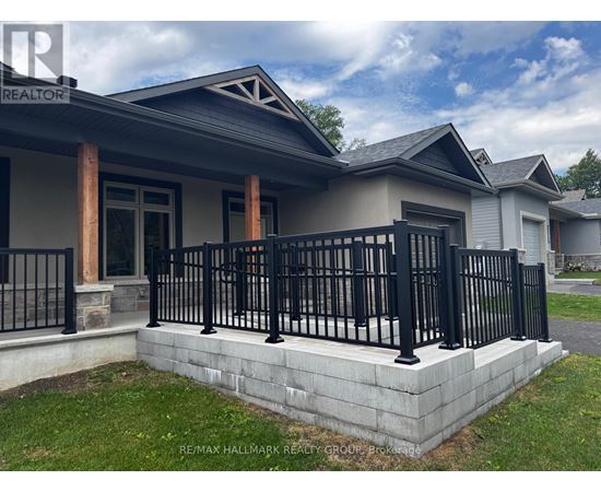 A house with a black fence and a grey roof.