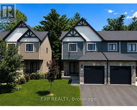 A house with a grey roof and a white garage door.