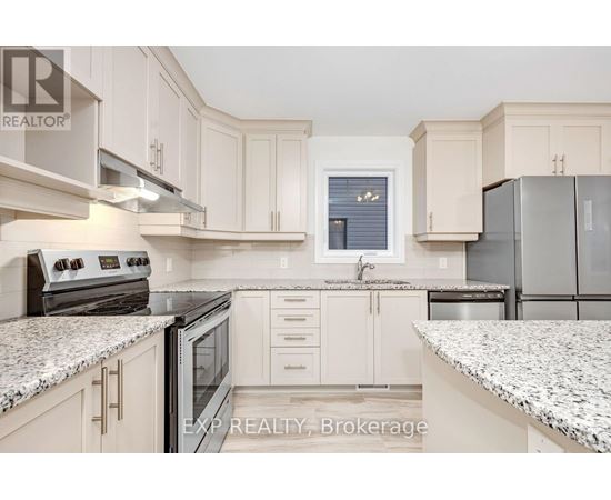 A kitchen with white cabinets and granite countertops.