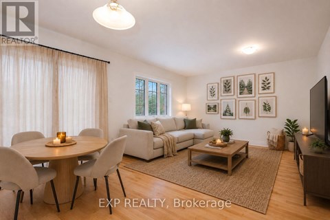 A well-lit living room with a dining table and chairs.