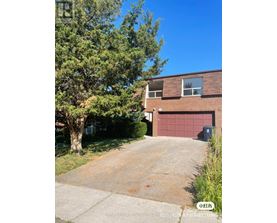 A house with a red garage door is for sale.