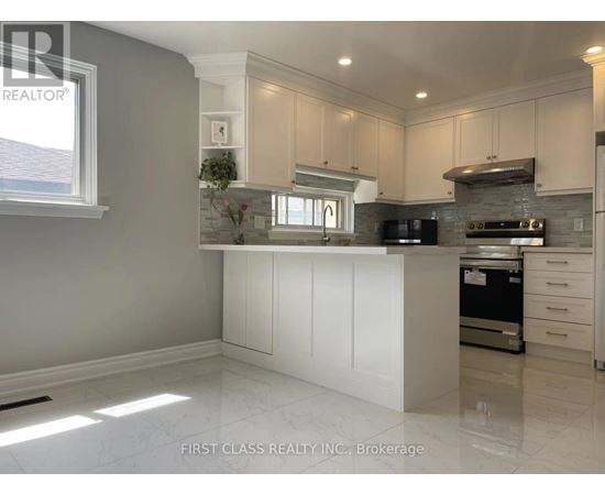 A kitchen with white cabinets and a marble floor.