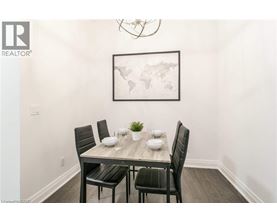 A dining room with a table set for two and a world map on the wall.