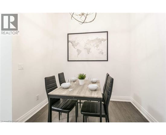 A dining room with a table set for two and a world map on the wall.