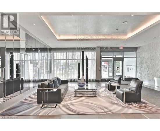 A large, modern living room with a long couch and a large rug.