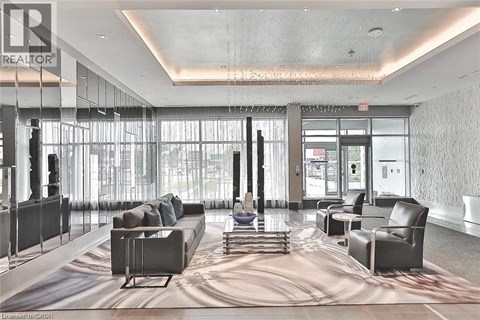 A large, modern living room with a long couch and a large rug.