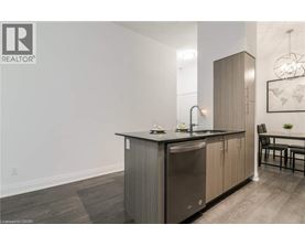 A modern kitchen with a sink and a refrigerator.