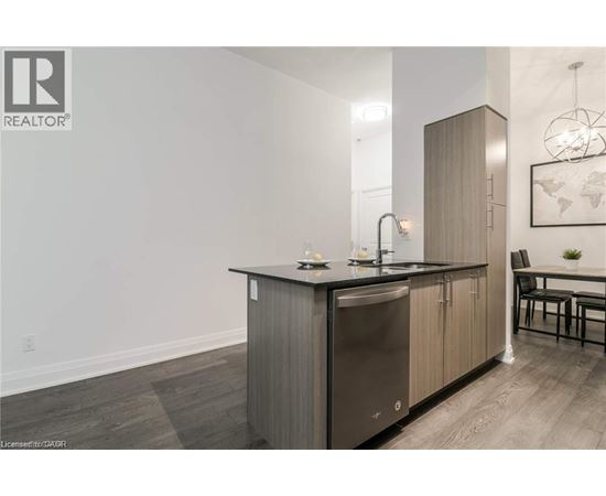 A modern kitchen with a sink and a refrigerator.