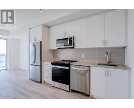 A kitchen with white cabinets and stainless steel appliances.