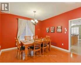 A dining room with a wooden table and chairs.