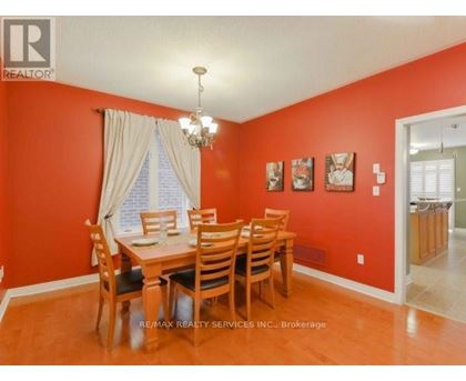 A dining room with a wooden table and chairs.