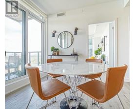 A dining room with a glass table and chairs.