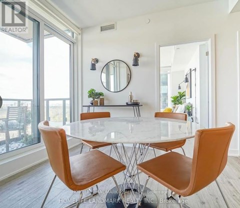 A dining room with a glass table and chairs.