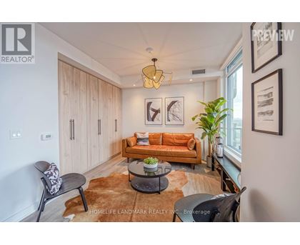 A living room with a brown rug and a brown couch.