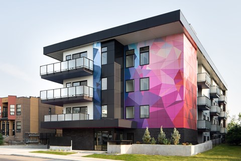 A modern building with a colorful mural on the side.