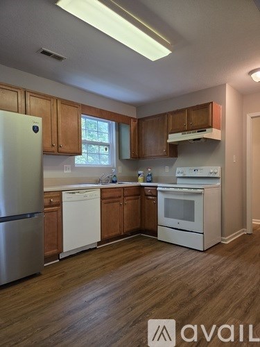 A kitchen with wooden cabinets and stainless steel appliances.