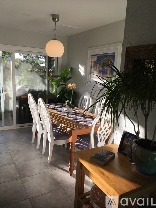 A dining room with a table and chairs.