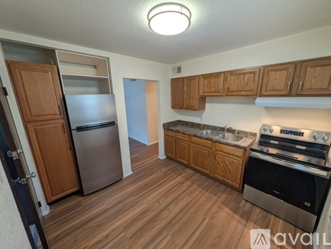 A room with two windows and carpeted flooring.