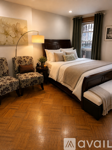 A bedroom with a large bed and a chair with a floral pattern.