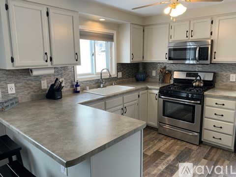 A kitchen with a stove, oven, and microwave.
