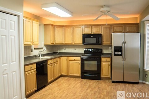 A kitchen with wooden cabinets and stainless steel appliances.