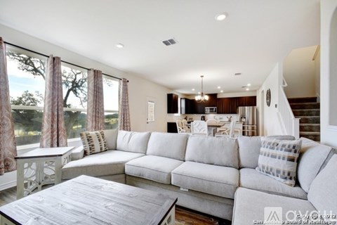 A living room with a white couch and a coffee table.