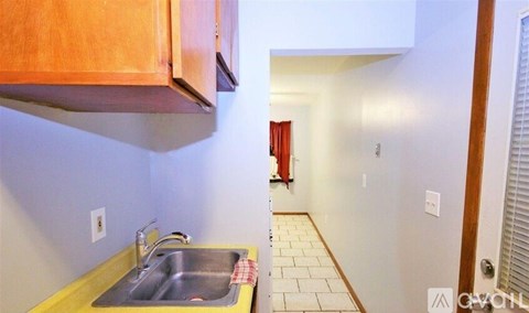 A kitchen with a sink and a counter.