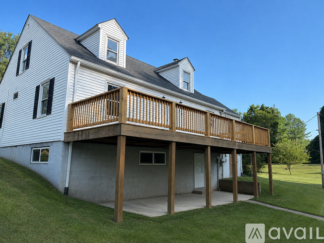 A large white house with a wooden deck.