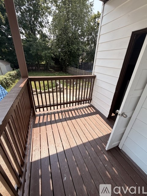 A deck with a railing and a door.