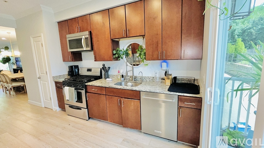 A kitchen with wooden cabinets and stainless steel appliances.