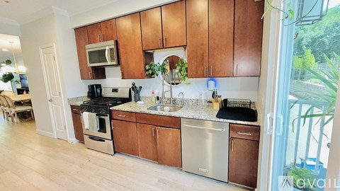A kitchen with wooden cabinets and stainless steel appliances.
