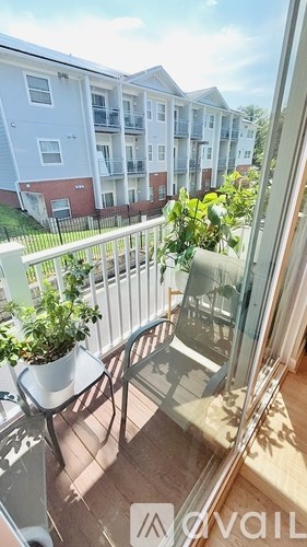 A balcony with a table and chairs overlooking a building.