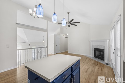 A kitchen with a white counter top and blue cabinets.