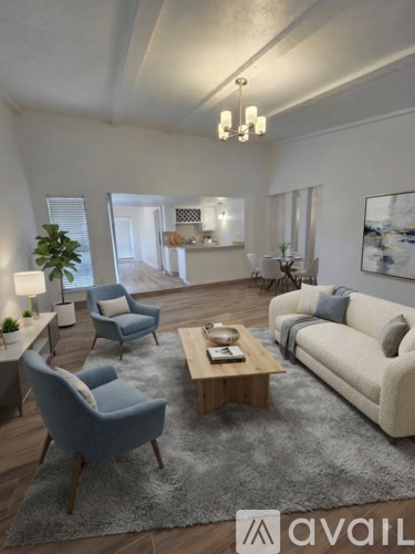 A living room with a sofa, chairs, and a coffee table.