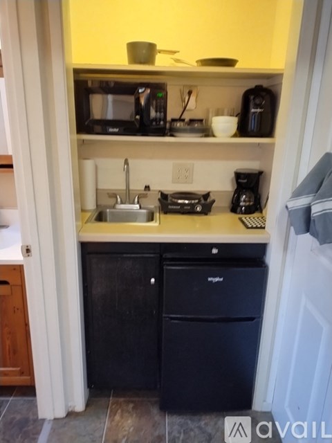 A kitchen with a sink, dishwasher, and microwave.