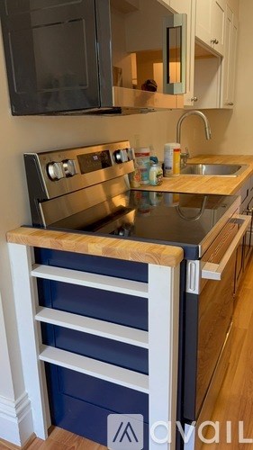 A kitchen with a stove top oven and a sink.