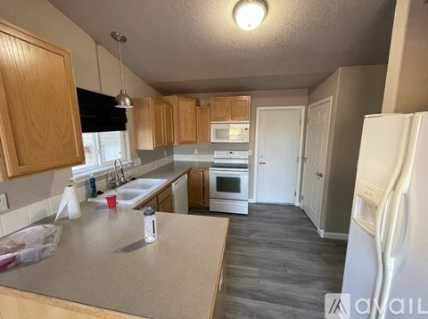 A kitchen with wooden cabinets and a white refrigerator.
