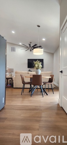 A modern dining room with a table set for four.