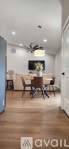 A modern dining room with a table set for four.