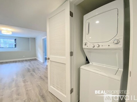 A white oven is in a kitchen with a white door.