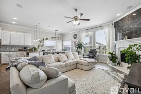 A modern living room with a large grey sectional sofa and a fireplace.