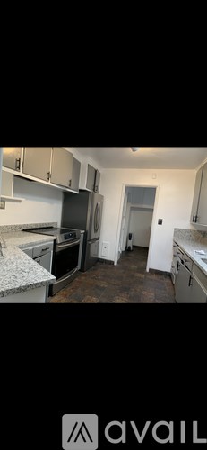 A kitchen with granite countertops and stainless steel appliances.