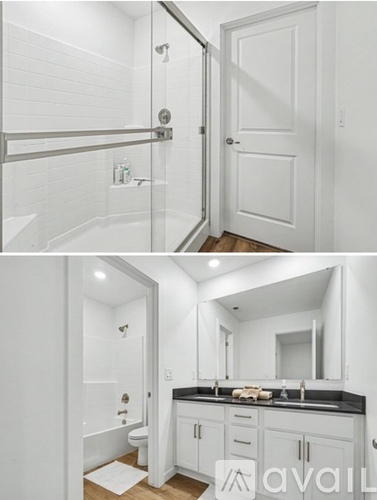 A bathroom with a white tub and a white door.